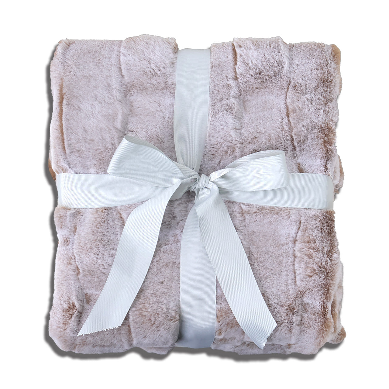 A folded soft pink plush blanket with a velvety texture, elegantly tied with a wide white satin ribbon bow at the center. The clean white background accentuates the blanket's gentle hue and the ribbon's crisp contrast, creating a warm, inviting aesthetic suitable for gift presentation or cozy home decor.