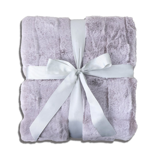A folded lavender-gray plush blanket with a velvety texture, tied with a silver-gray satin ribbon bow at the center. The clean white background emphasizes the blanket's soft color palette and elegant detailing, creating a serene and sophisticated presentation suitable for product display.