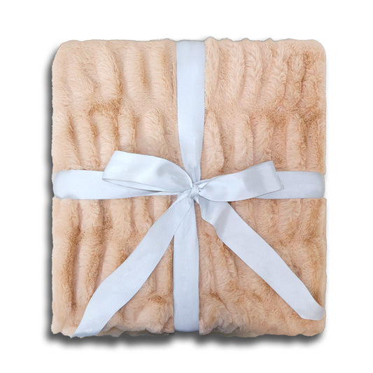A plush, beige textured blanket is tied with a light blue satin ribbon in a bow at the center.