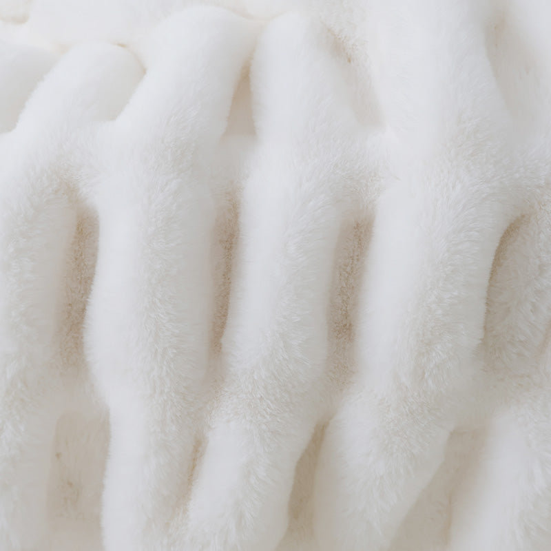 A close-up of a white plush fabric with vertical ribbed texture and velvety appearance.