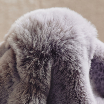 A plush gray-to-lavender gradient blanket with a fur-like texture, embracing a minimalist, natural aesthetic through its seamless color blend and unadorned design.