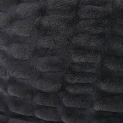A close-up of a dark plush fabric with raised rounded segments arranged in a grid pattern.